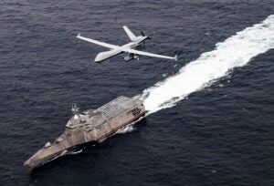 An MQ-9 SeaGuardian unmanned maritime surveillance aircraft system flies over Independence-variant littoral combat ship USS Coronado (LCS-4) during U.S. Pacific Fleet’s Unmanned Systems Integrated Battle Problem (UxS IBP) 21 on April 21, 2021. (Photo: U.S. Navy by Chief Mass Communication Specialist Shannon Renfroe)